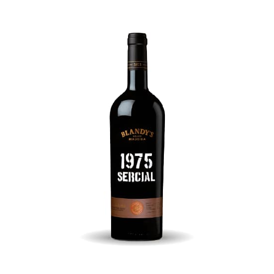 A dark Blandy’s Madeira bottle with white stencil lettering identifying the 1975 Sercial vintage.