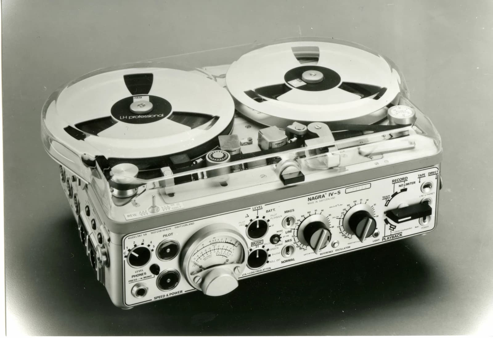 An archival Nagra IV-S stereo tape recorder with two reels, control knobs and its front-panel meter.