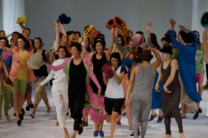 Models move together in colourful Pleats Please garments in a 1993 presentation.