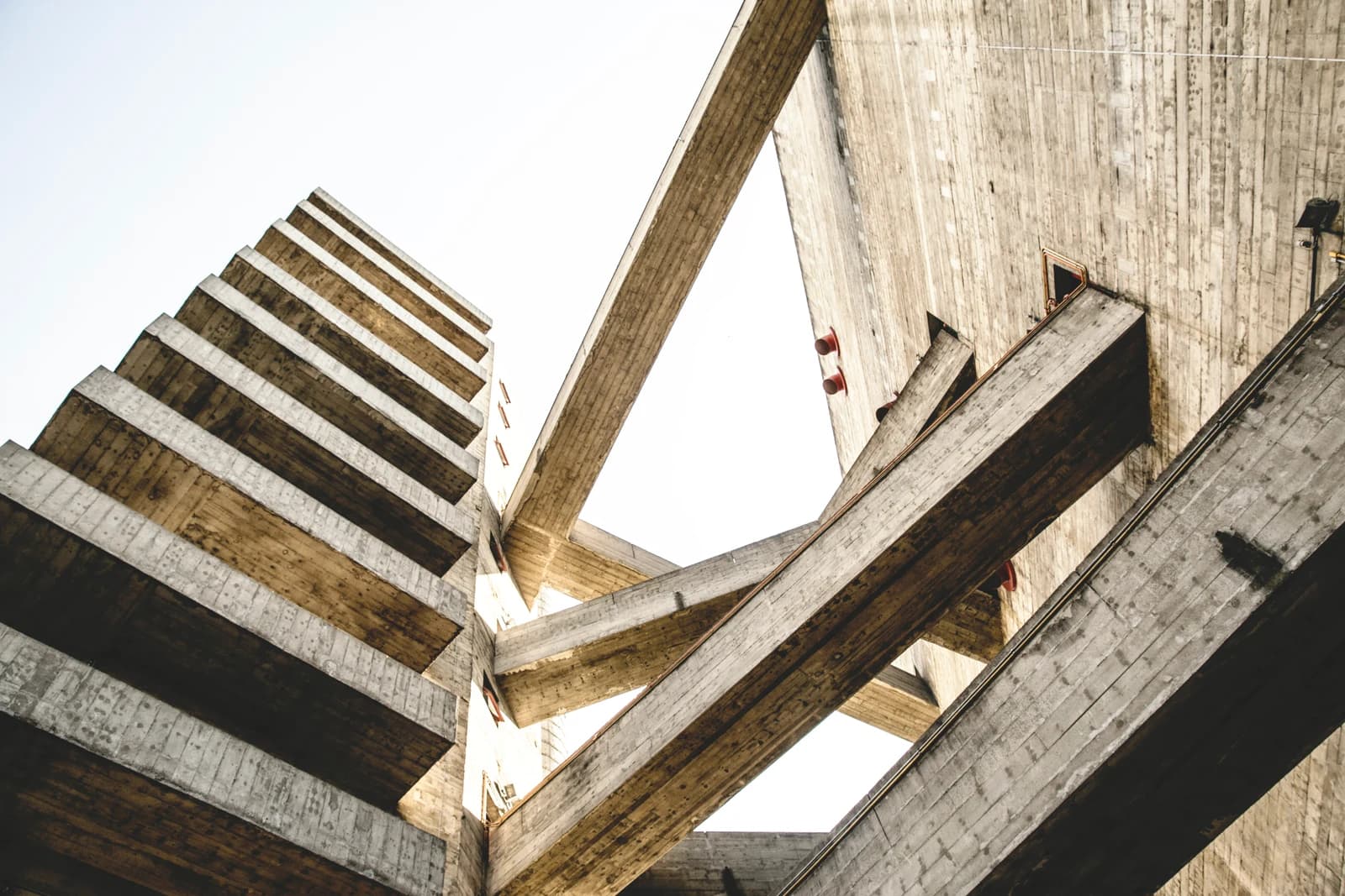 Concrete bridges cross between the sports towers at Sesc Pompeia, seen from below.