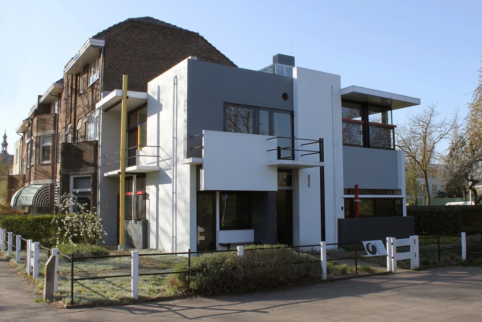 White and grey planes, black window frames and primary-colour details at the Rietveld Schröder House.