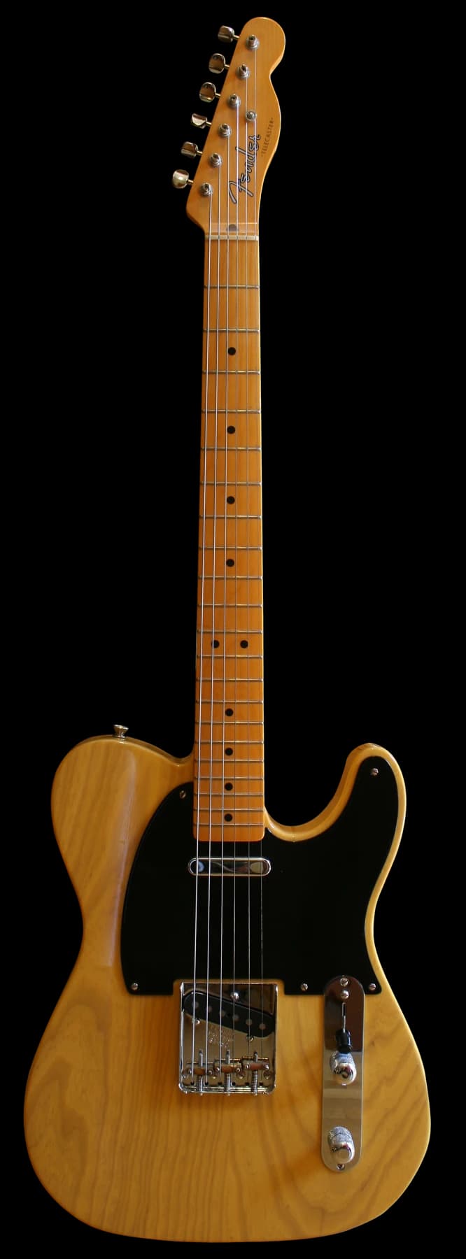 A complete yellow Fender Telecaster American Vintage 1952 model guitar, with a maple neck and black pickguard, shown upright.