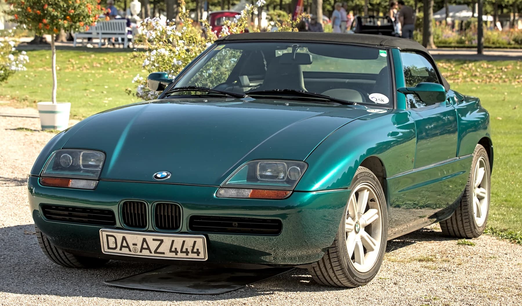 A green BMW Z1 roadster photographed from the front three-quarter angle at an outdoor classic-car gathering.