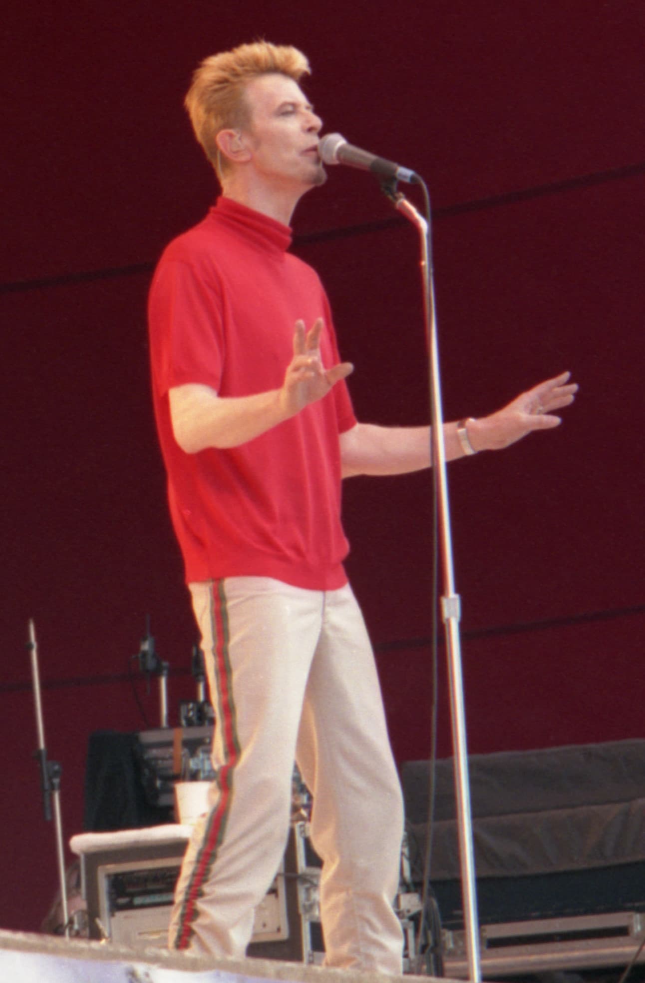 David Bowie performing in a red shirt at the Ruisrock Festival in Finland in June 1997.