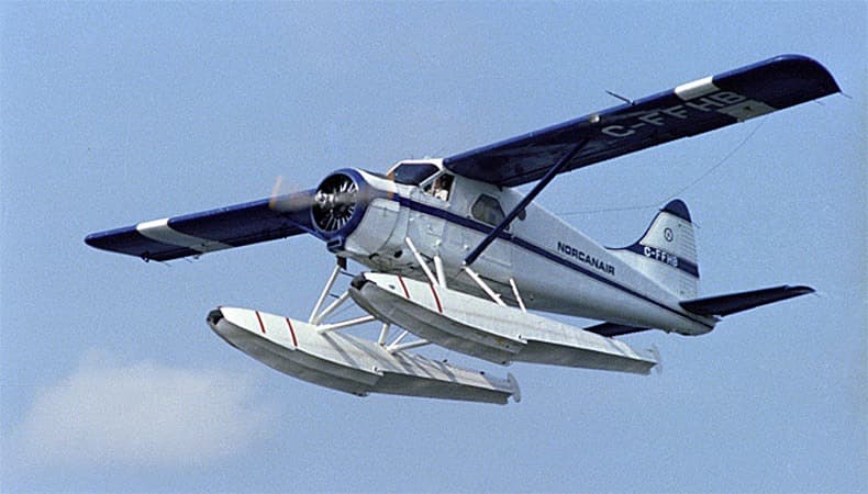 De Havilland Canada DHC-2 Beaver prototype CF-FHB flying above water on floats.