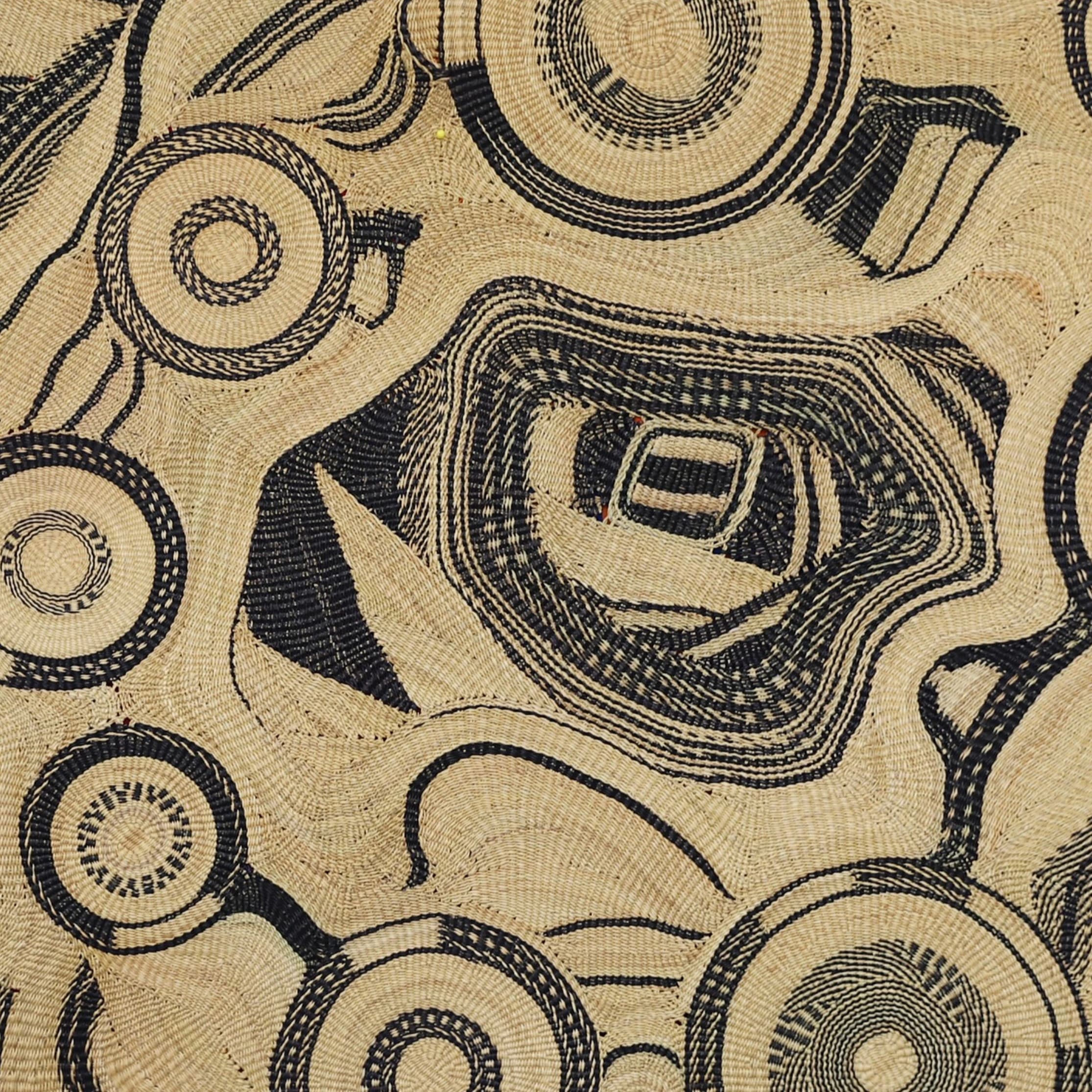 A close and full view of a Frafra Tapestry woven in contrasting dark and natural elephant grass.