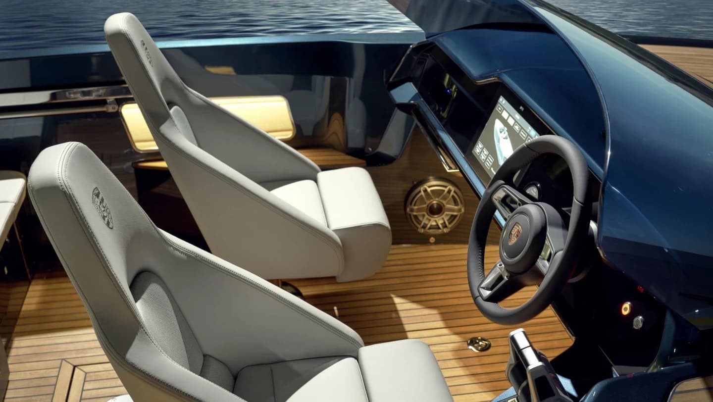 The Frauscher x Porsche 790 Spectre cockpit, with pale upholstered seats, a dark blue control panel and a timber deck surrounding the driving position.