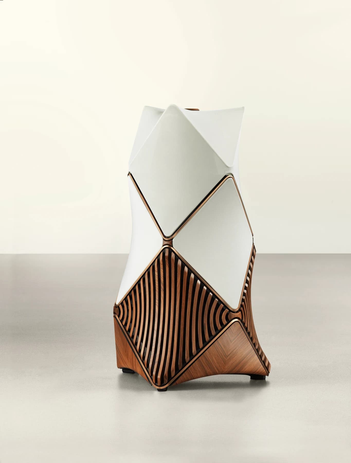 A complete Beolab 90 Monarch loudspeaker, with pale upper acoustic covers, curved wooden framing and an open wooden lamella structure at its base.