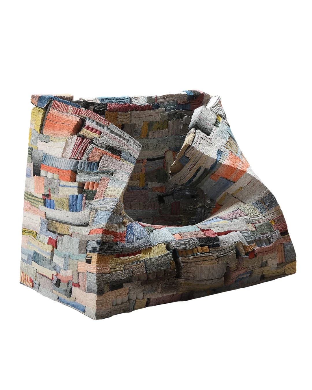 Jongjin Park’s chair-like Strata of Illusion sculpture, with slumped walls and a dense surface of layered grey, blue, yellow and red ceramic sections.