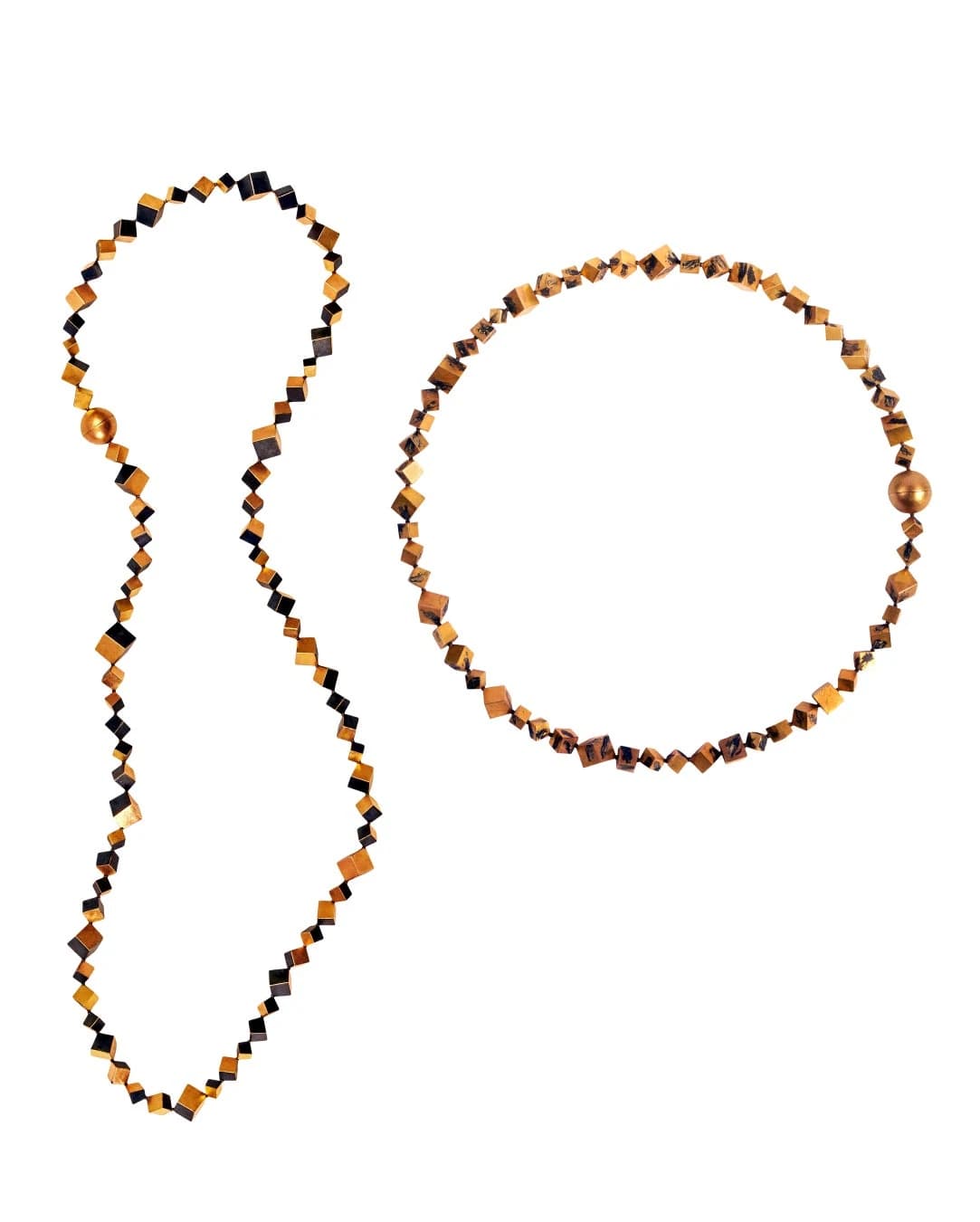 Two Graziano Visintin Collier necklaces on white, assembled from tiny gold cubes with contrasting dark niello faces and irregular black surface marks.