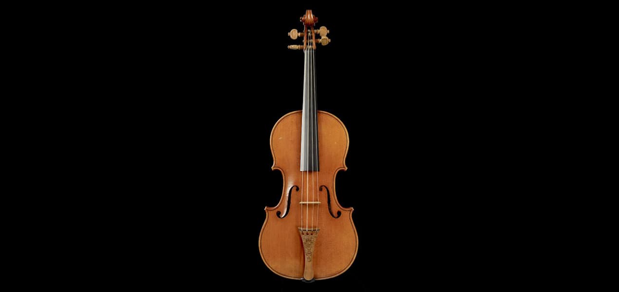 The 1716 Messiah violin by Antonio Stradivari shown upright against a deep black background.