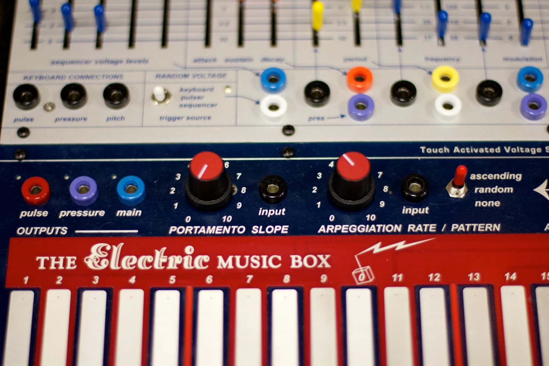 Close view of a Buchla Music Easel showing coloured patch sockets, small controls and the striped touch-sensitive playing surface.