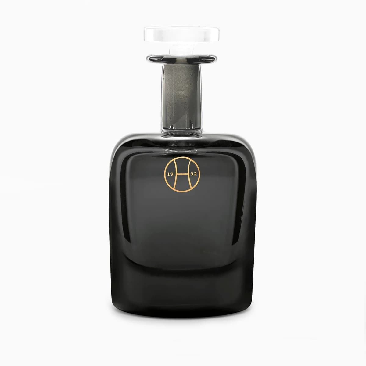 A dark handblown Perfumer H Dust bottle with a clear glass stopper.