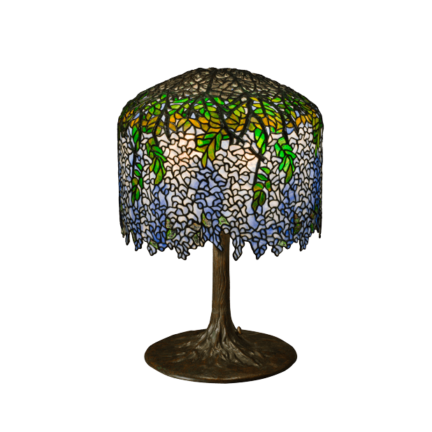 A Tiffany Studios Wisteria lamp with blue and white glass blossoms above a bronze tree-trunk base.