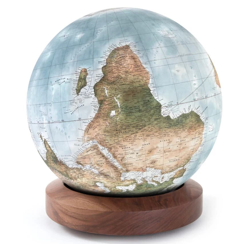 An upside-down globe with Africa inverted above a walnut base.