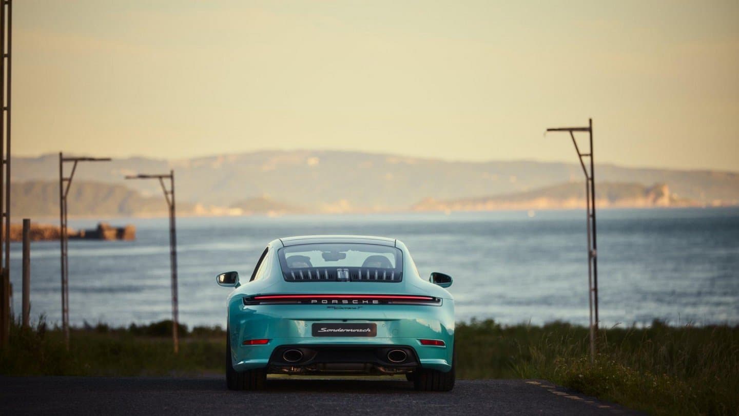 Rear view of the blue Porsche 911 Carrera T Formosa overlooking the sea, from Porsche’s 2025 press gallery.